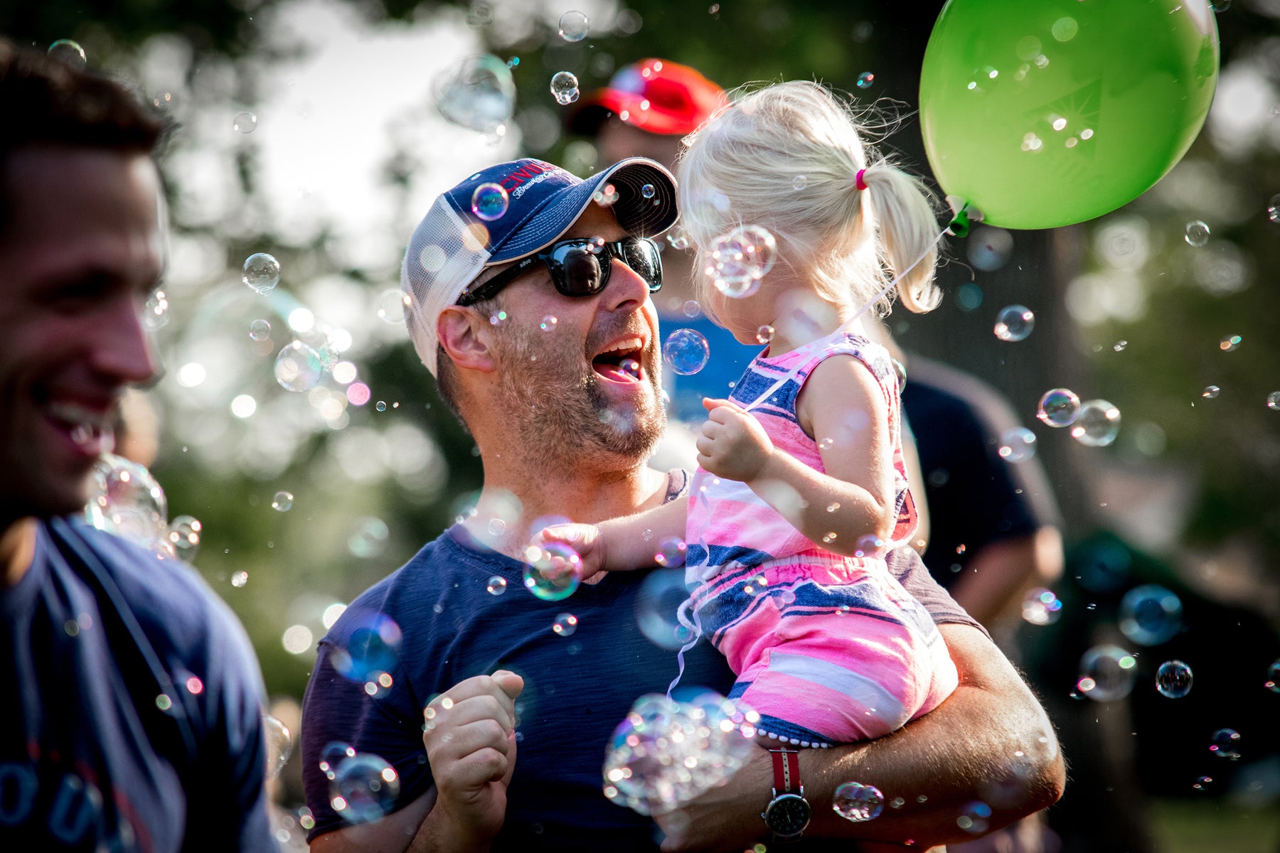 Father and daughter having a blast at a bubble party