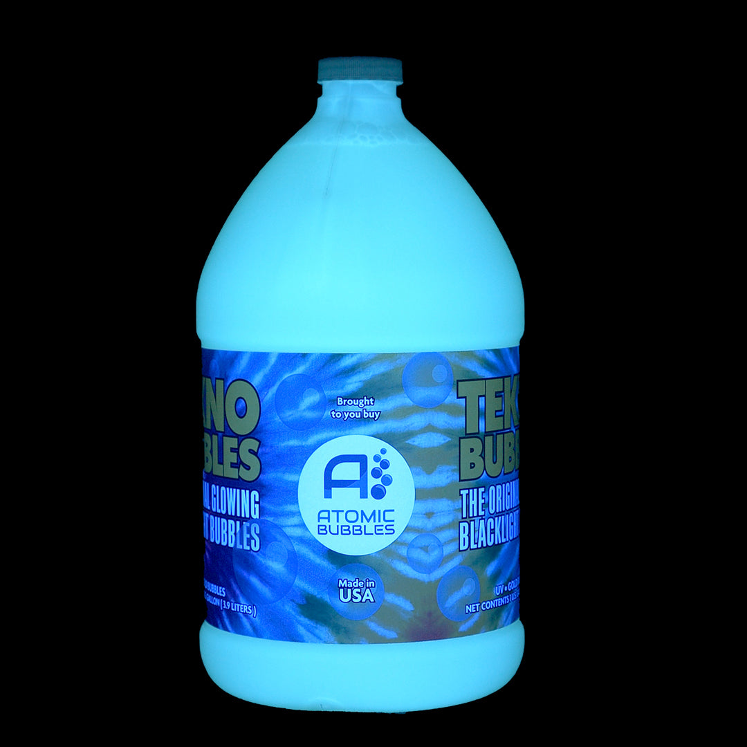 Gallon of Tekno Bubbles® Gold under blacklight