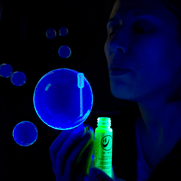 Blowing Tekno Bubbles® under Blacklight